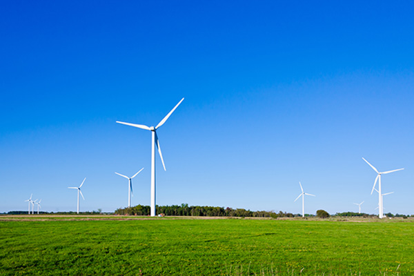 Wind turbine on green grass background